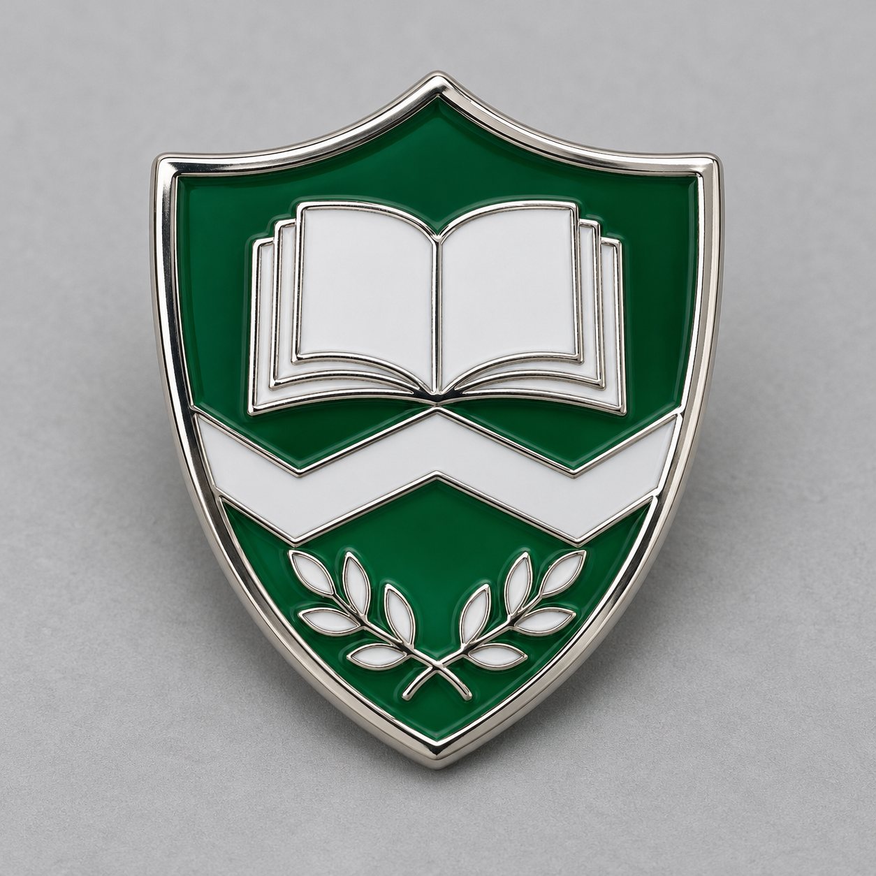 Silver school crest badge with green and white hard enamel